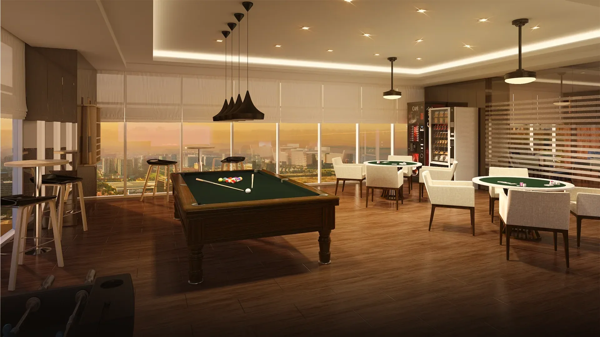 The game room at Coast Residences: billiards table, card tables and bar seating against floor-to-ceiling windows.