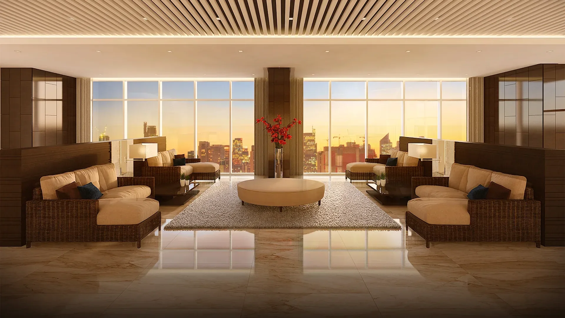 A residents' lounge at Coast Residences, with floor-to-ceiling windows looking over the city at sunset.